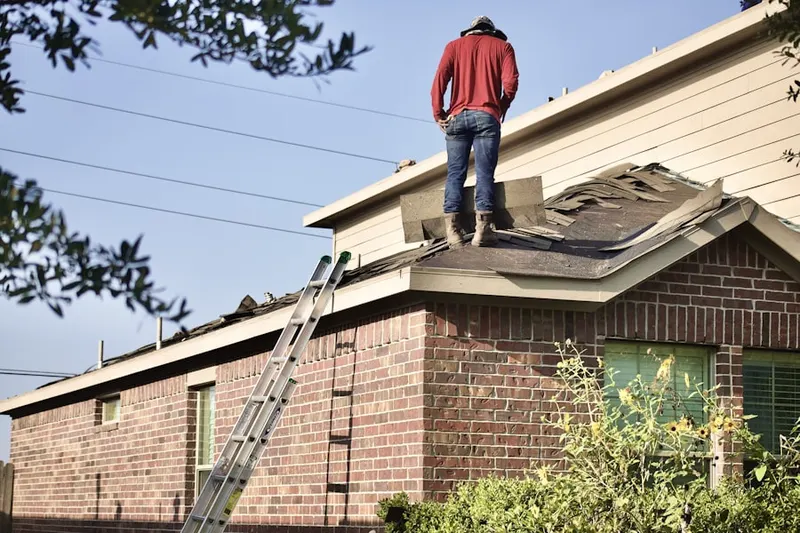Professional roofer working on a residential roof in North Star